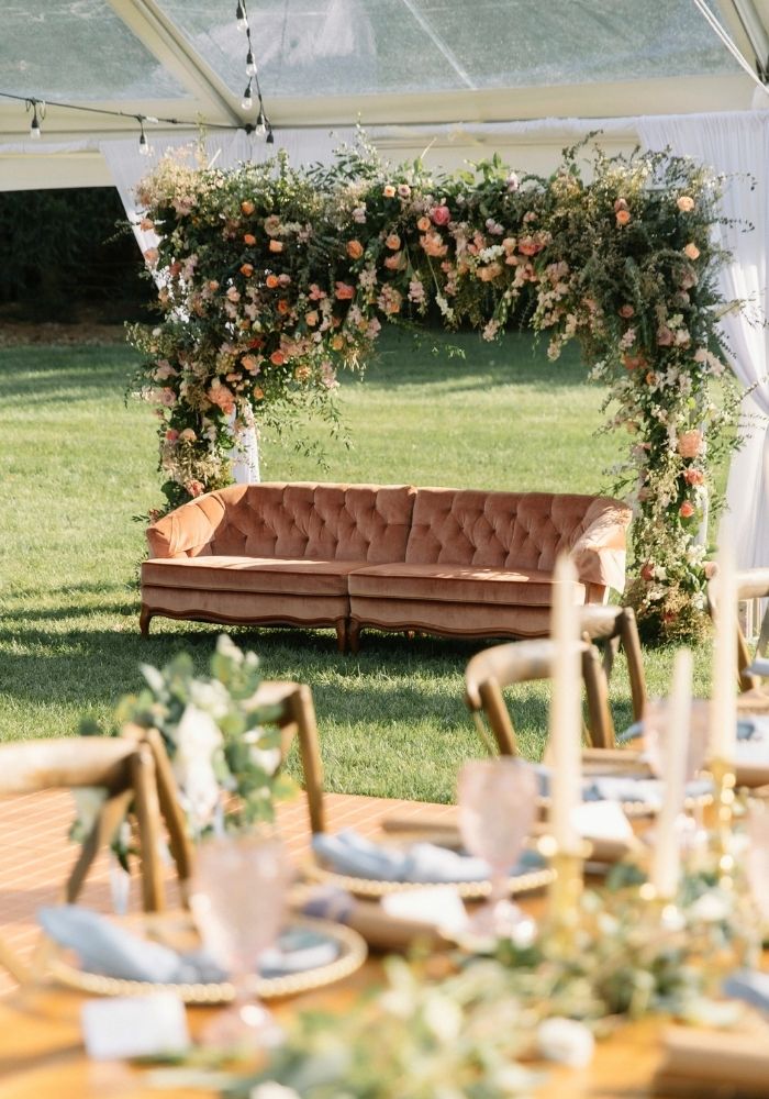 Nikkah decor in Metro Detroit — outdoor fresh floral arch and velvet sofa setup by Bridal Insignia Events