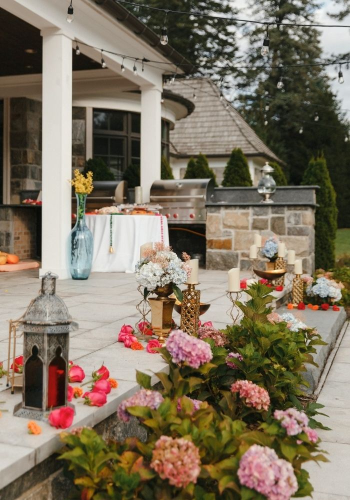 Outdoor wedding celebration setup with fresh florals and lanterns — Nikkah decor in Metro Detroit by Bridal Insignia Events