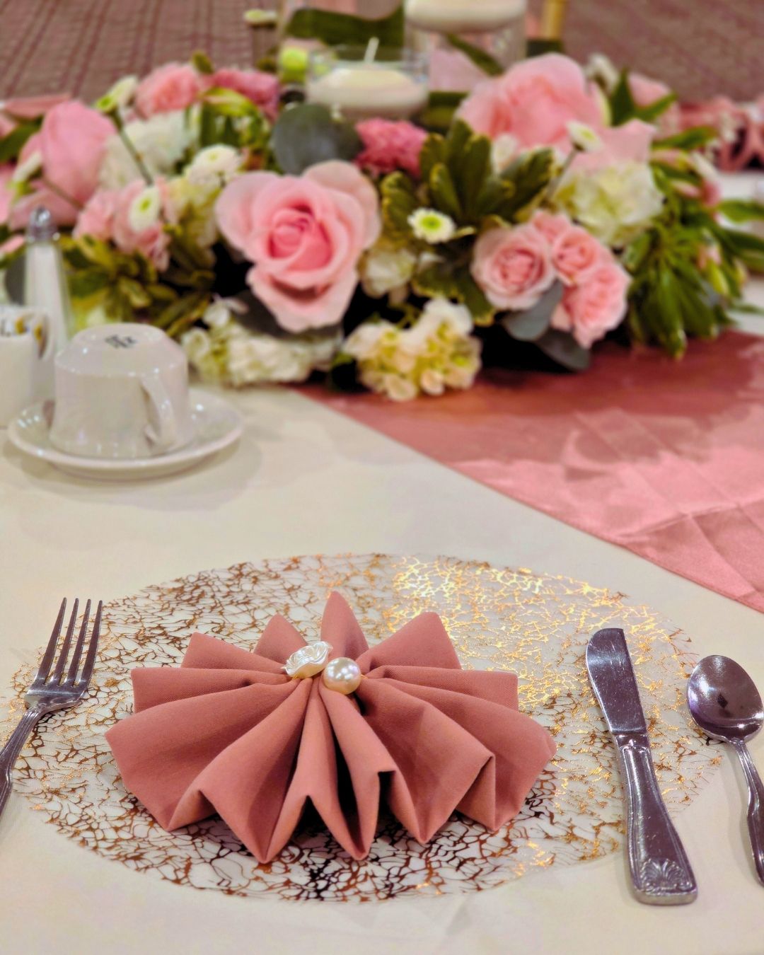 Custom sweetheart table with fresh floral centerpieces highlighting Quinceanera decor in Metro Detroit.