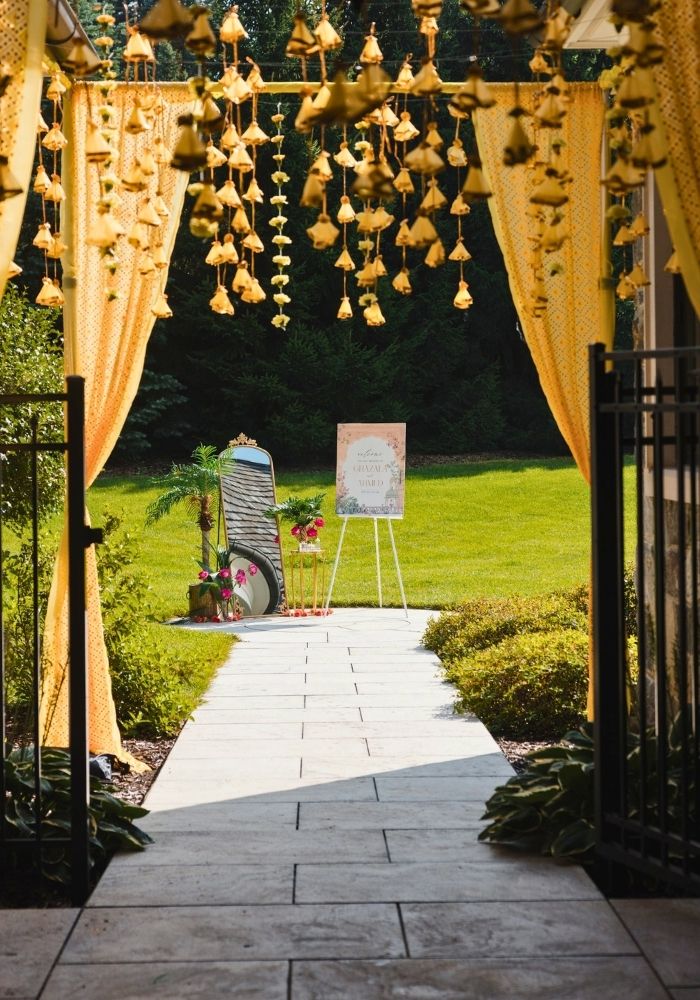 Mandap decorator in Metro Detroit — South Asian wedding entrance design with bell garlands by Bridal Insignia Events