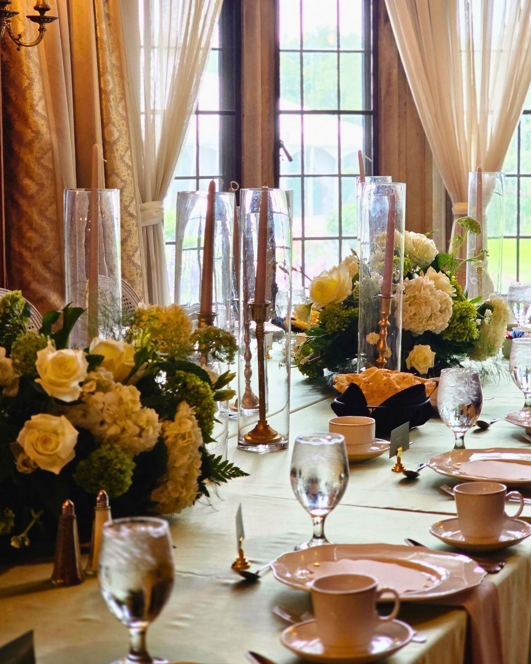 Wedding decorator at Meadow Brook Hall, fresh floral garlands tracing the Grand Staircase by Bridal Insignia