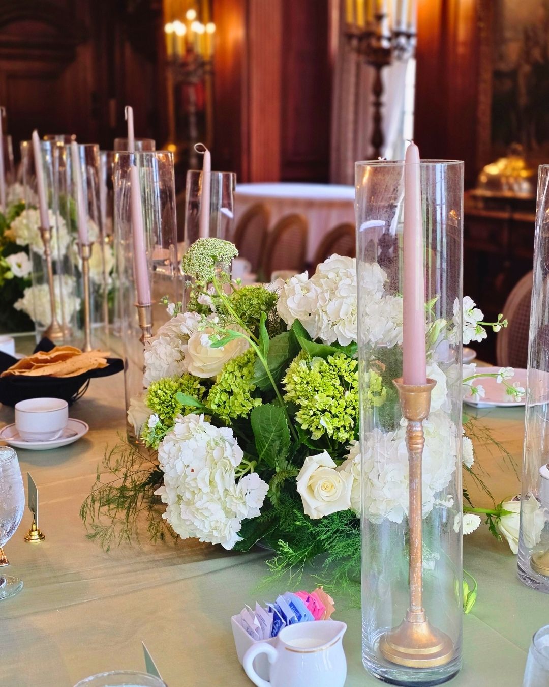 Wedding decorator at Meadow Brook Hall in Rochester, tall fresh floral centerpieces in the mansion ballroom by Bridal Insignia
