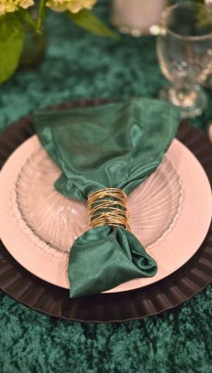 Wedding party rentals in Metro Detroit by Bridal Insignia — elegant tablescape with transparent charger plate and satin napkin fold