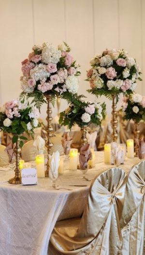 Elegant wedding head table decor in Metro Detroit by Bridal Insignia — gold stand centerpiece with fresh white roses and lush greenery