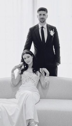 A couple during their post-wedding photoshoot surrounded by elegant engagement party decor in Metro Detroit by Bridal Insignia